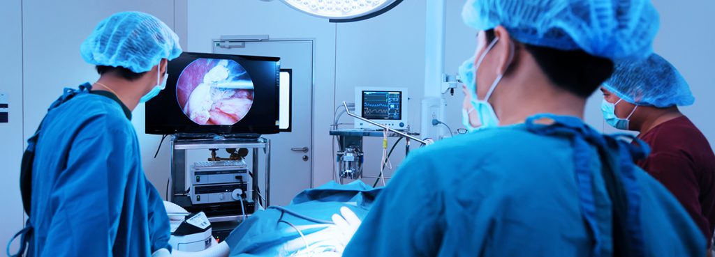 Surgeons performing a laparoscopic hernia repair